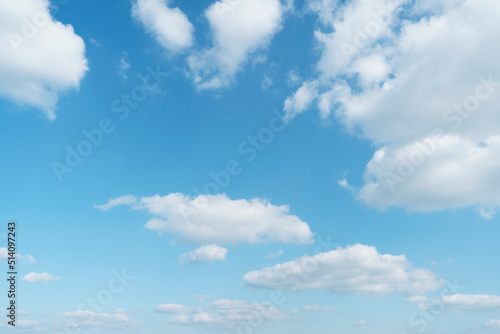 Beautiful clouds during spring time in a Sunny day. Blue sky and white fluffy clouds © tassita