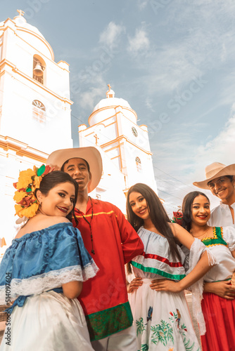 Teenagers from Nicaragua with traditional Latin American clothing with the cathedral church of Jinotega in the background