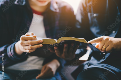 Christian couple or group reading study the bible together and pray at a home or Sunday school at church. concept studying the word of god. photo