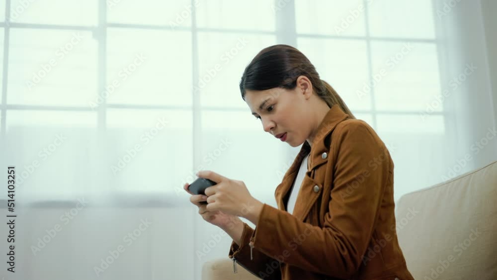 Wow. Happy beautiful woman surprise and excited when playing games at mobile phone sitting sofa in living room at home. Successful female achieve their goals business. Smartphone concept. Wow. Happy beautiful woman surprise and excited when playing games at mobile phone sitting sofa in living room at home. Successful female achieve their goals business. Smartphone concept.