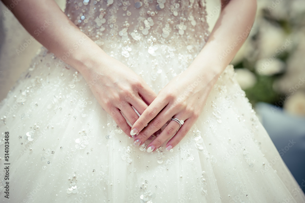 Bride hand with a wedding ring on the background of dress Bride hand with a wedding ring on the background of dress