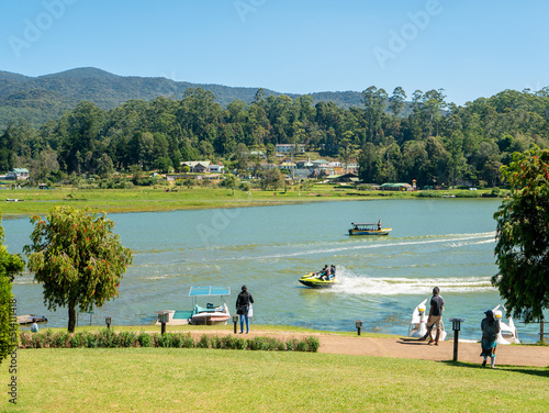 Nuwara Eliya, Sri Lanka - March 10, 2022: People walk in Gregory Park and go boating on the lake on a sunny day