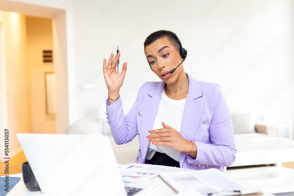 Fototapeta premium Portrait of woman doing video call using laptop. Businesswoman with headset talking during online meeting with colleague. Albino woman working from home over a video conference on computer.
