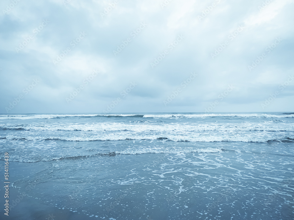 Blue ocean wave on the sea with cloudy sky background