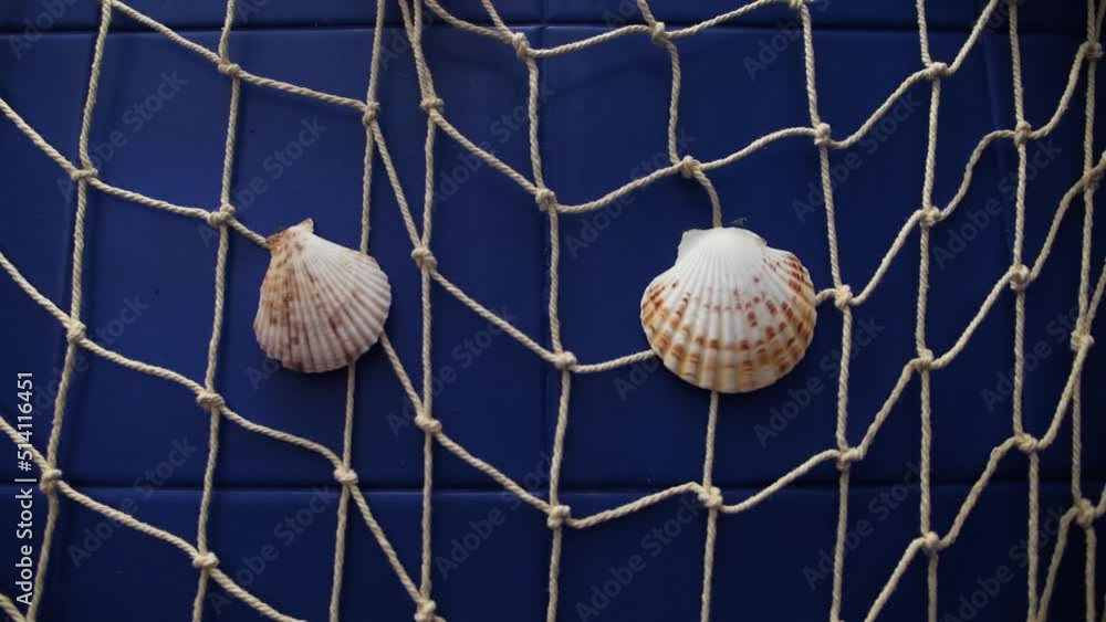 Seashells stacked on fishing net as ornament in bathroom, pan right Seashells stacked on fishing net as ornament in bathroom, pan right