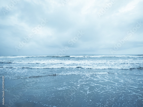 Blue ocean wave on the sea with cloudy sky background