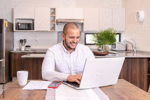 Young man working from home and using the networks to communicate.  