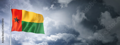 Guinea Bissau flag on a cloudy sky photo