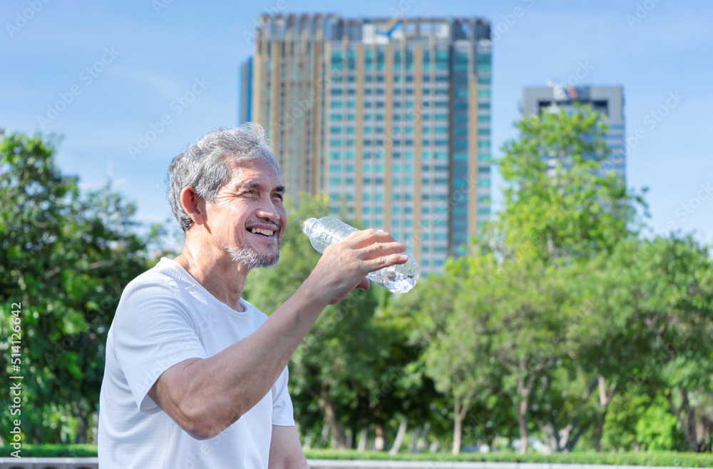 Happy asian senior man in sportswear is drinking water from bottle after workout in the city park, concept elderly people lifestyle, workout, activity, health, healthcare Happy asian senior man in sportswear is drinking water from bottle after workout in the city park, concept elderly people lifestyle, workout, activity, health, healthcare