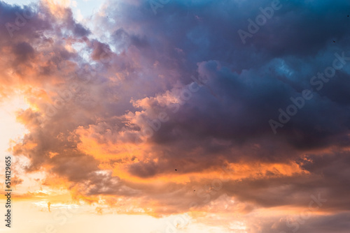 Beautiful evening sky with colorful clouds. Sunset sky with puffy clouds. Textured sky background