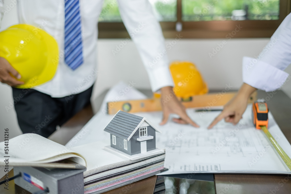 Team of male and female engineers and architects, working meeting, discussing construction, and home design projects. House design concept Team of male and female engineers and architects, working meeting, discussing construction, and home design projects. House design concept