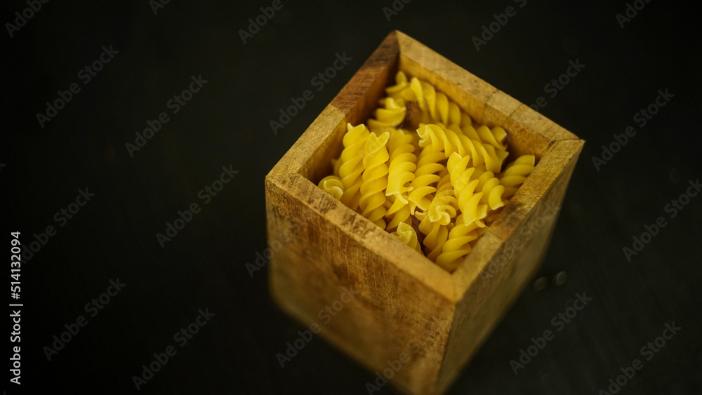 pasta in a dish dry appetizing spiral macaroni in the kitchen food preparation