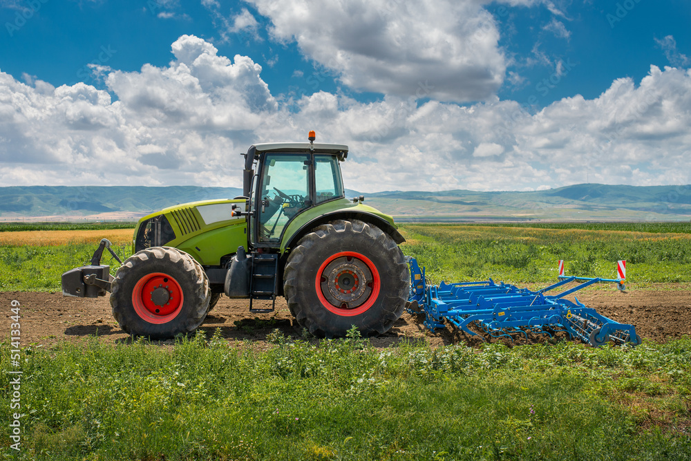 Fototapeta premium Land cultivation by the tractor