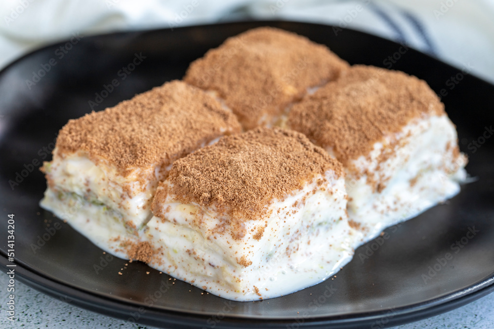 Cold baklava. Baklava with milk on a white background. Turkish cuisine delicacies. close up Cold baklava. Baklava with milk on a white background. Turkish cuisine delicacies. close up