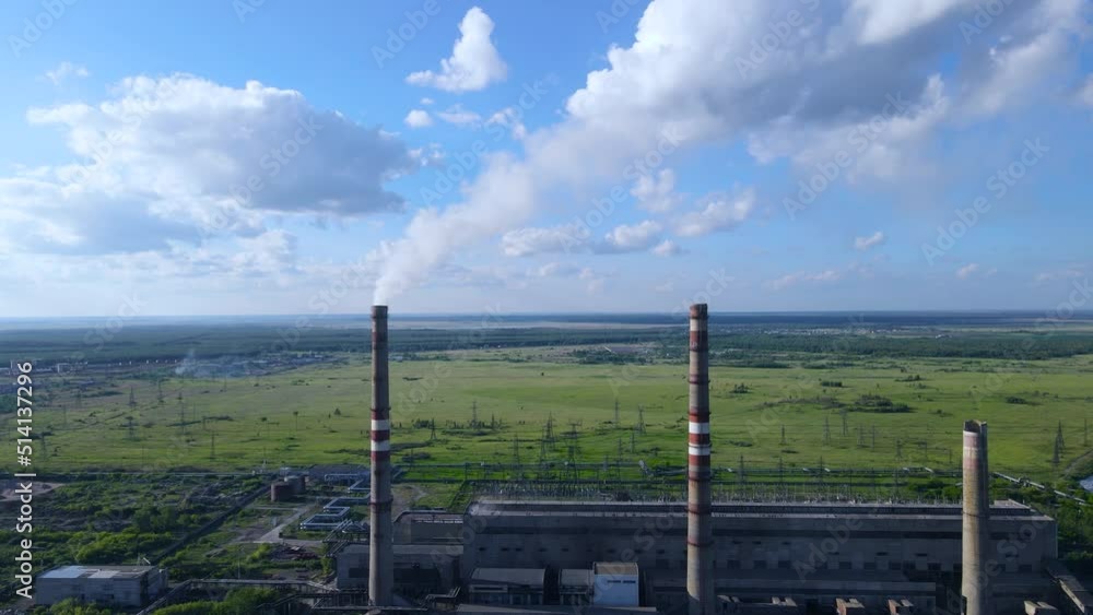 Carbon dioxide emissions into the atmosphere. Coal burning at power plants. Smoke from the chimney of the power plant. Thick smoke from a huge factory chimney.Cheap electricity.Environmental pollution Carbon dioxide emissions into the atmosphere. Coal burning at power plants. Smoke from the chimney of the power plant. Thick smoke from a huge factory chimney.Cheap electricity.Environmental pollution