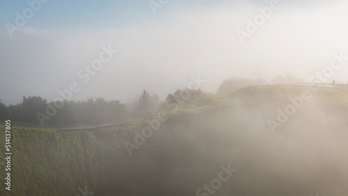 Thick fog drifting over volcanic crater at Mt Eden summit  Auckland