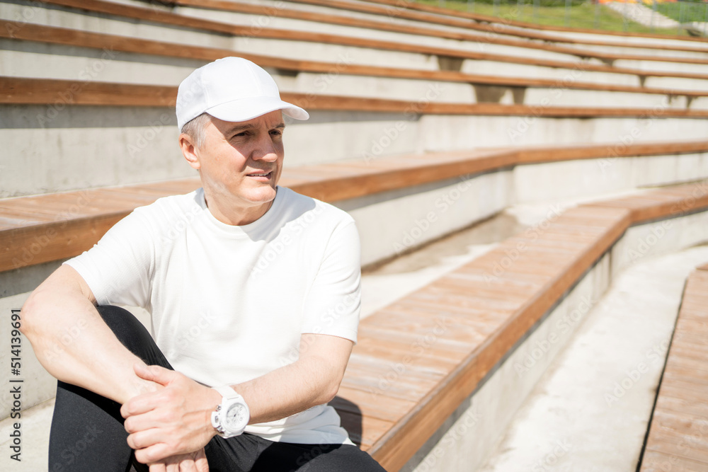 An old adult male, actively training for health, uses a fitness watch measuring pulse and calories. An old adult male, actively training for health, uses a fitness watch measuring pulse and calories.
