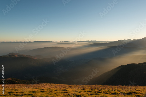 Foggy sunset in the mountains. Mist is covering the hills in the early evening.