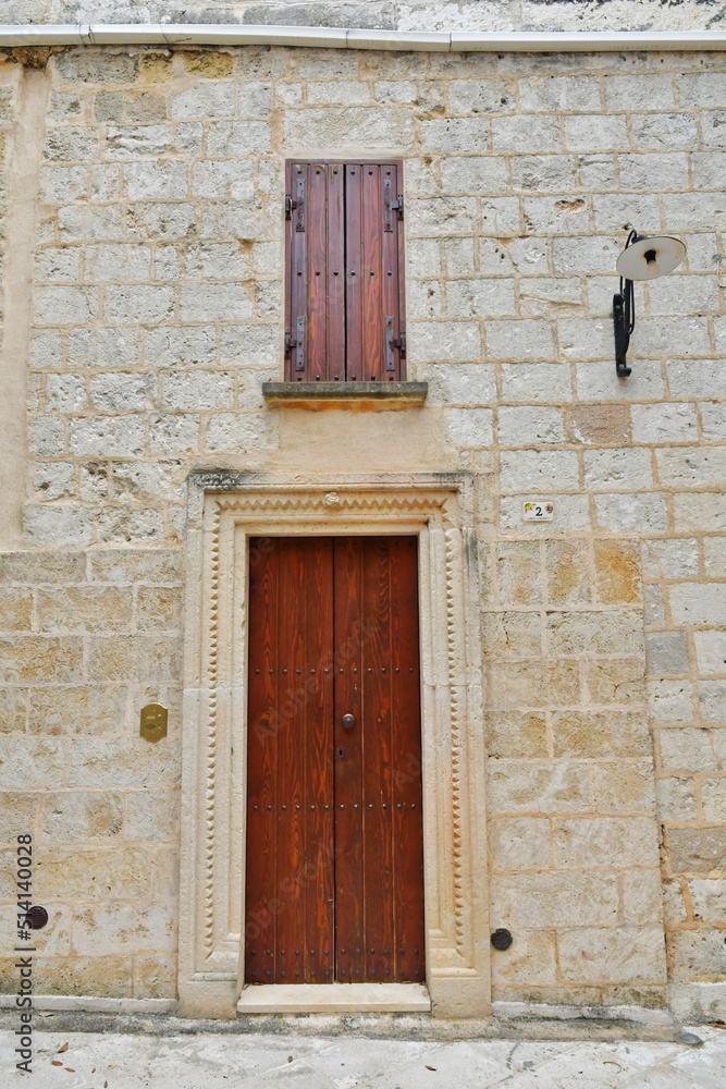 The door of an ancient house in the historic center of Tricase, a medieval town in the Puglia region, Italy.