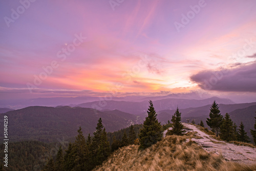 Sunset in the hills with the valley below. Dramatic clouds at dusk.