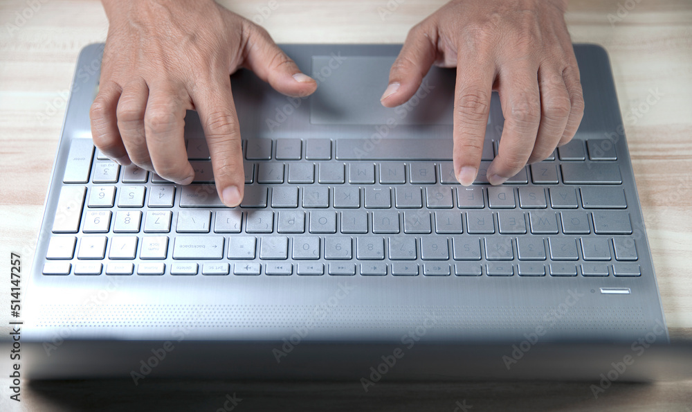 businessman working on computer top view of hand typing something on computer keyboard businessman working on computer top view of hand typing something on computer keyboard