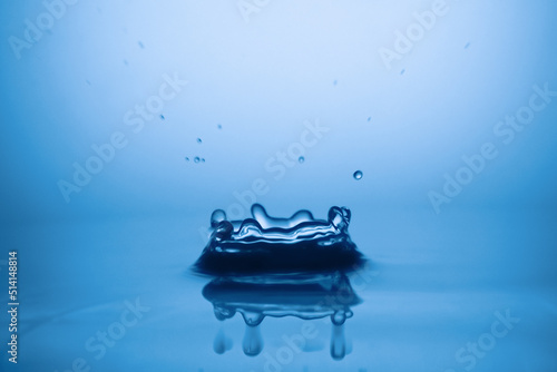 Drops of water and splashes. Blue splash water drop, round water drop, water drop in glass, drop, splash, spray, abstract shape out of water . Water shape abstract background concept.