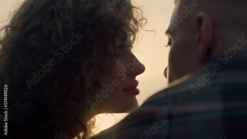Closeup romantic couple kissing at sunset. Cheerful girl and guy dating on beach