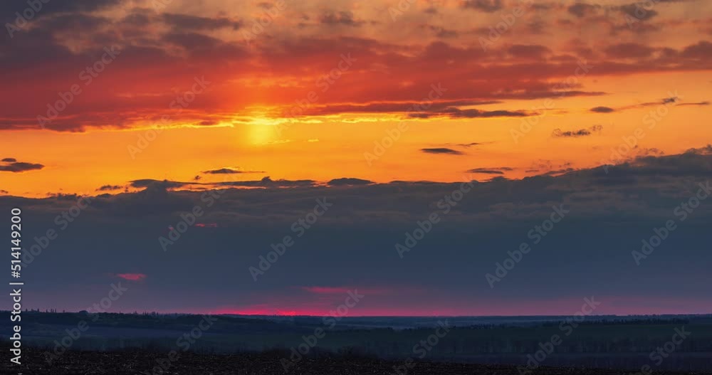 Bright colorful dramatic clouds in the sky during sunset in the fields time lapse Bright colorful dramatic clouds in the sky during sunset in the fields time lapse