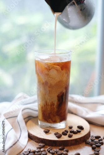 Making homemade Iced brew coffee with milk in the tall glass