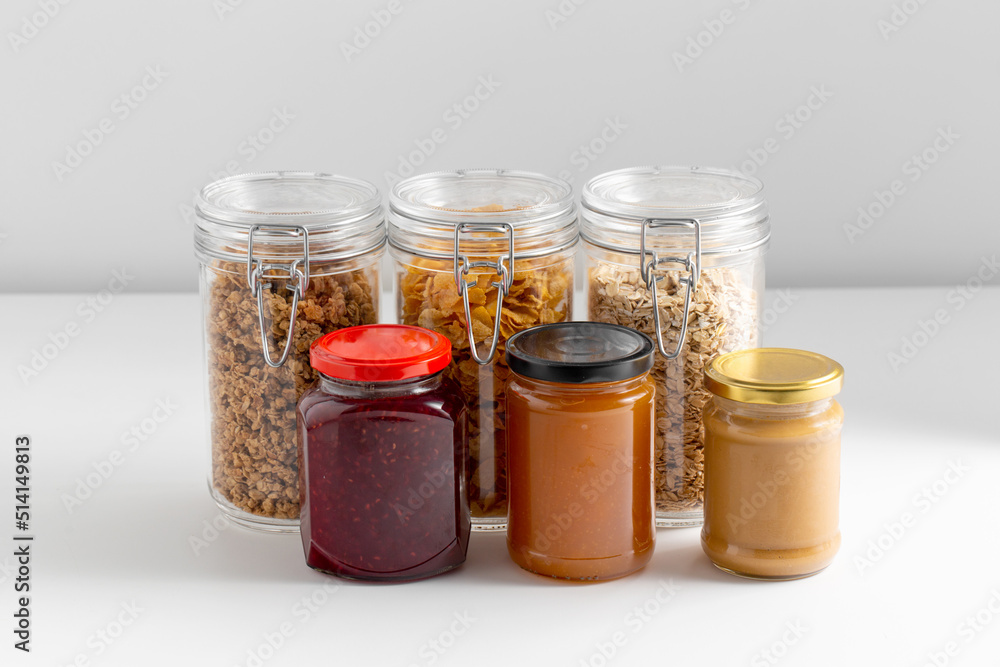 food, eating and storage concept - close up of preserves and cereals on table food, eating and storage concept - close up of preserves and cereals on table