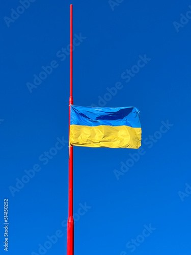 Blue and yellow flag of Ukraine against the clear sky - Stand with Ukraine