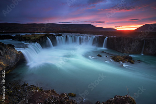 Stunning sunset over Godafoss Waterfall with smooth flowing in Iceland