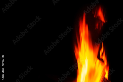 Fire flames blurred in motion at long exposure  on a black background.