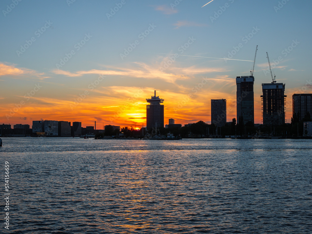 Sunset in Amsterdam with skyline and buildings Sunset in Amsterdam with skyline and buildings