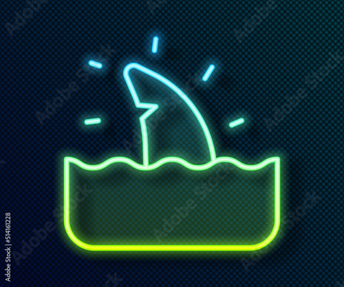 Glowing neon line Shark fin in ocean wave icon isolated on black background. Vector