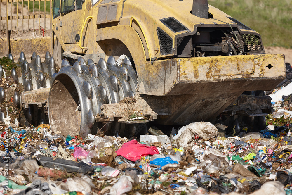 Heavy machinery shredding garbage in an open air landfill. Pollution Heavy machinery shredding garbage in an open air landfill. Pollution