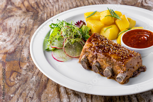 Pork ribs in honey mustard sauce and boiled potatoes