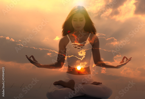 Foto Young meditation woman feeling free on nature at sunrise.