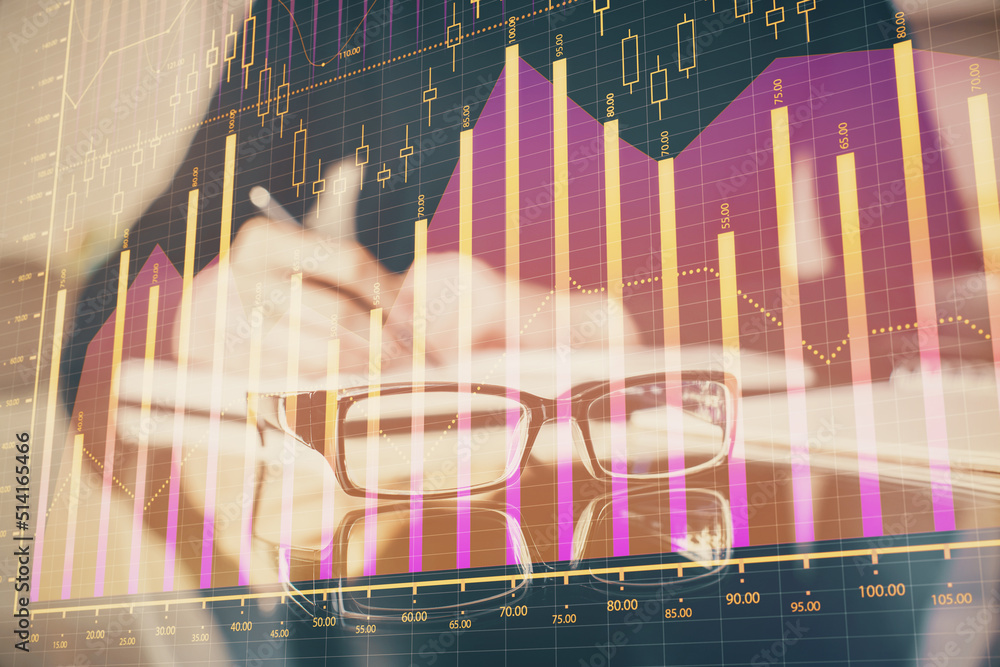 Forex chart hologram on hand taking notes background. Concept of analysis. Double exposure Forex chart hologram on hand taking notes background. Concept of analysis. Double exposure