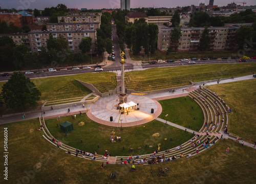 Siauliai, Lithuania - 23rd june, 2021: Aerial view St. Johns midsummer festival concert in city Siauliai with people sitting in sun clock listening live music. Siauliai. Lithuania