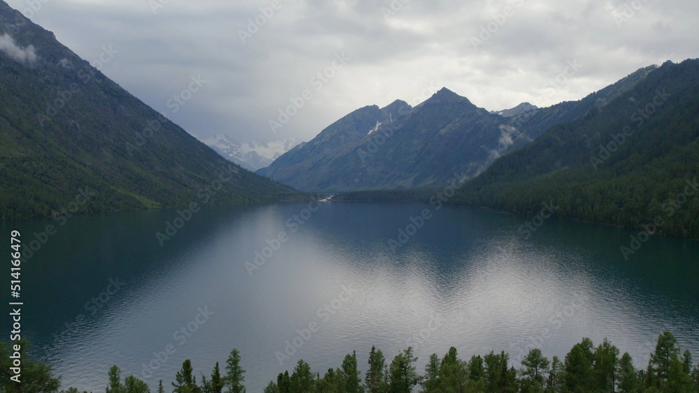 Multin lakes in the middle of mountains under dramatic sky in Altai