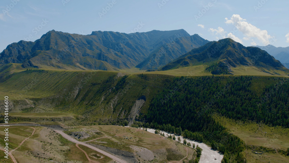 Green mountains of Altai and river under clear blue sky