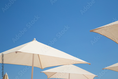 Sun umbrellas on the beach © Ruslan Mitin