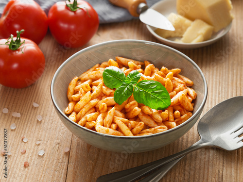 Close up cooked cavatelli pasta in tomato sauce photo