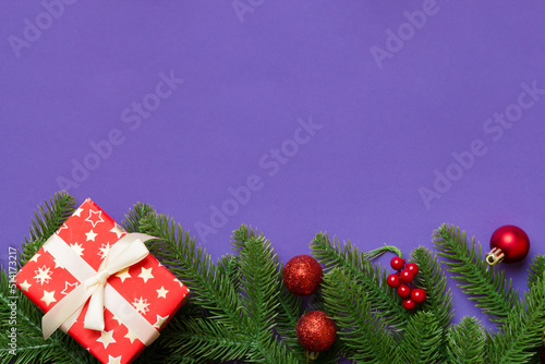 Christmas decorations and fir tree branch and gift boxon dark table. Top view frame with copy space