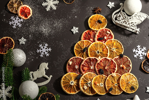 Festive fir tree from dried fruits. Christmas or New Year festive flat lay  food creative