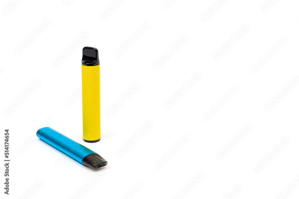 Two electronic cigarettes disposable and refillable with a replaceable cartridge in a blue and yellow body, photographed against a white background Two electronic cigarettes disposable and refillable with a replaceable cartridge in a blue and yellow body, photographed against a white background