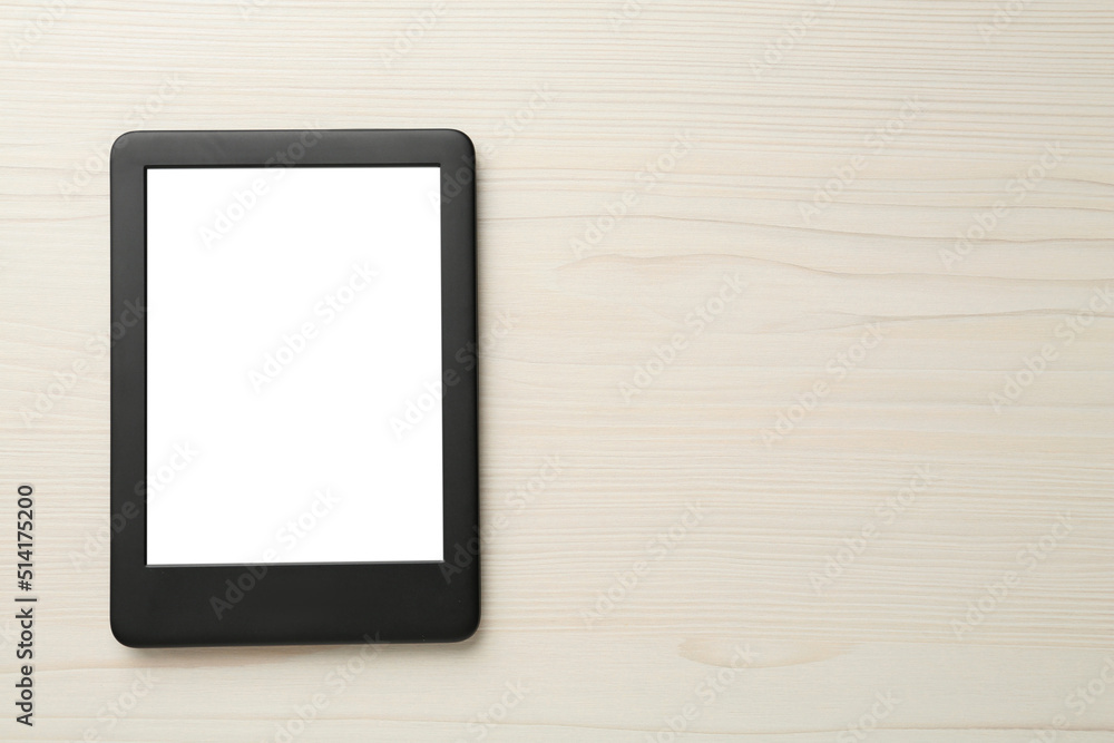 Modern e-book reader with blank screen on white wooden table, top view. Space for text Modern e-book reader with blank screen on white wooden table, top view. Space for text