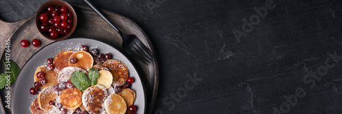 Panel kuchenny z motywem Cereal pancakes with cranberries served on black table, top view with space for text. Banner design