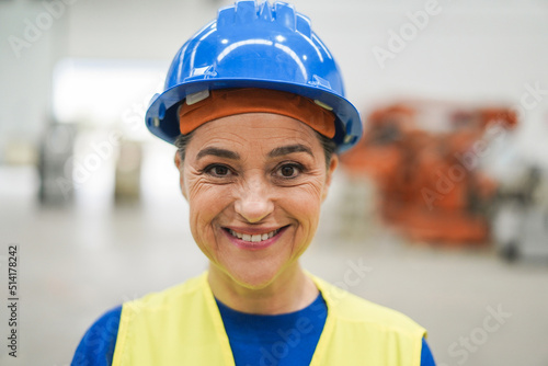 Senior engineer woman working inside robotic factory - Focus on eyes